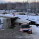 A car is trapped on a collapsed section of the offramp of Minnesota Drive in Anchorage, Friday, Nov. 30, 2018.
